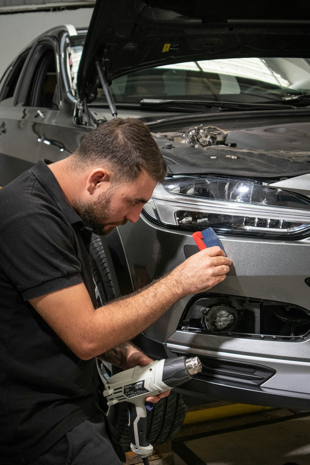 a man working on a car in a garage